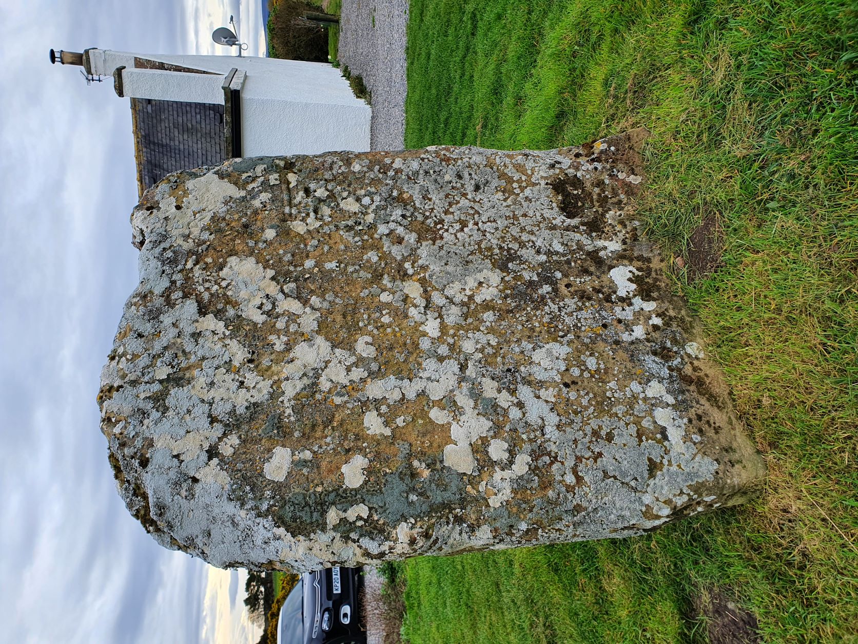 The cross-face of the Kebbuck Stone, eroded and overgrown with lichen