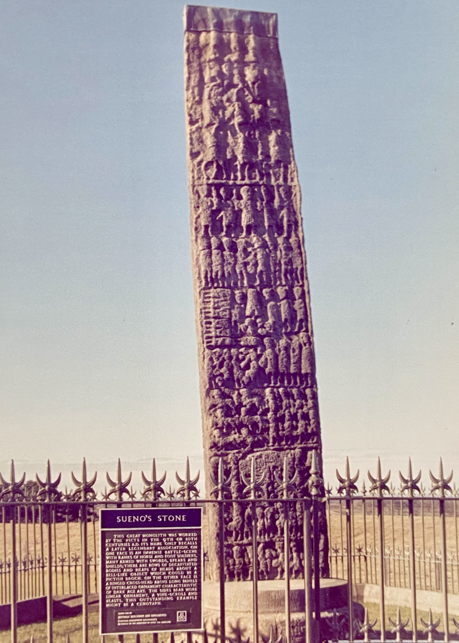 Photo of Sueno’s Stone near Forres, taken in the 1980s by Ronnie Nielson. Photo shows the east face of the stone with its tiers of battle scenes.