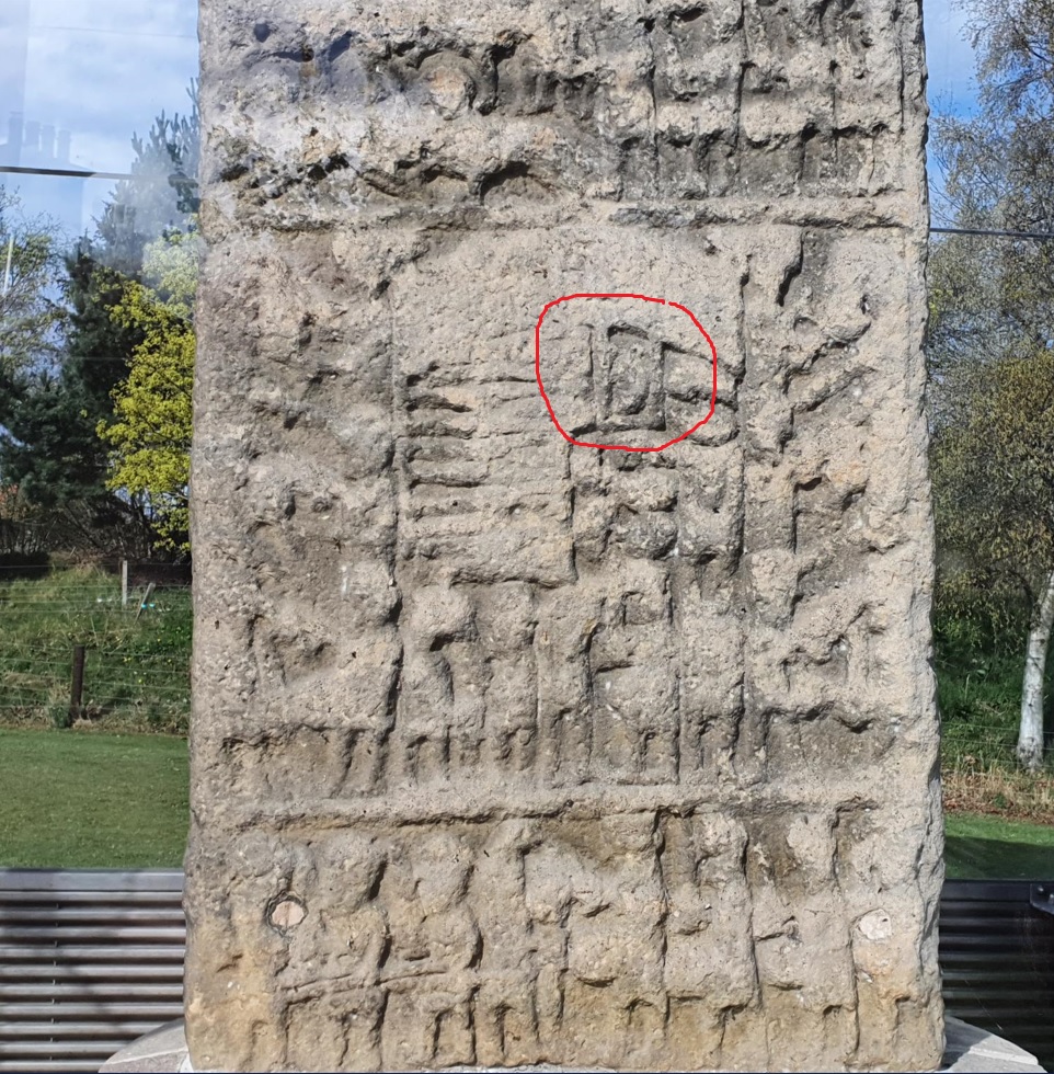 Battle-scene carvings on Sueno’s Stone, with the severed head in a box circled in red beneath an arched object which has been interpreted as the bridge of Kinloss. Sueno's Stone is a carved sandstone pillar dating to between 850 and 950 AD, so the carvings are very worn and hard to make out.